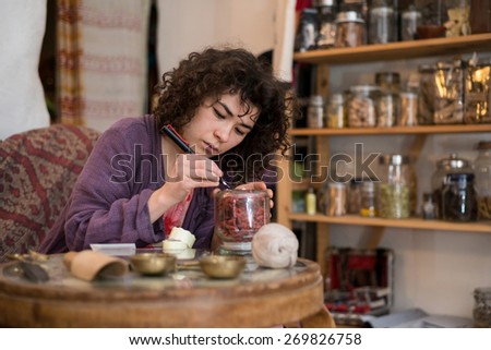 Asian woman writes dealer price tag on the goods in the store