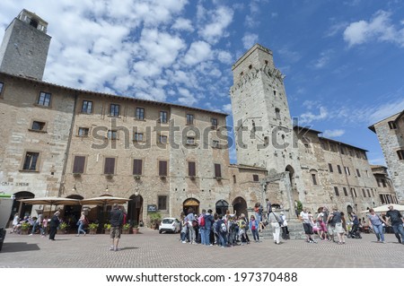 SAN GIMIGNANO , ITALY - MAY 13 : Tourists in San Gimignano on May 13, 2014 in San Gimignano, Italy. UNESCO declared the town a World Heritage Site.