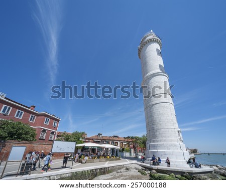 Venice, Italy - May 8, 2014: Lighthouse on Murano island in Venice, Italy. Murano is  well known immaculate glass art work. For visitors to Venice, it is a well known and visited destination.