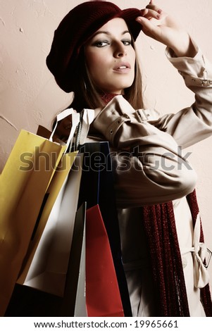 Portrait of young beautiful women with her shopping bags (retro tones)