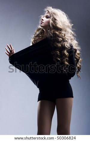 Portrait of the beautiful woman with long curly hair