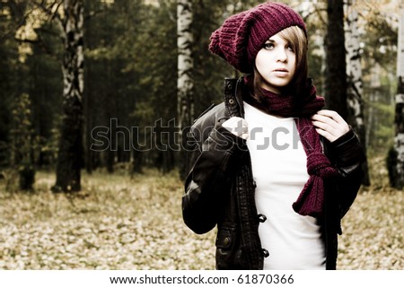 Portrait of beautiful young woman in autumn forest