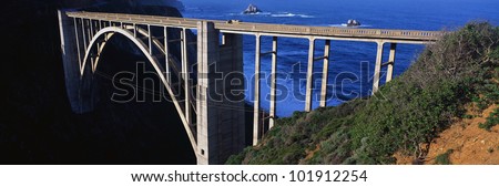 This is the Bixby Bridge that carries the Pacific Coast Highway. The Pacific Ocean is to the right of the bridge.