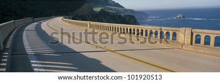 This is the Pacific Coast Highway on the Bixby Bridge. It is next to the mountainous coast and the Pacific Ocean.