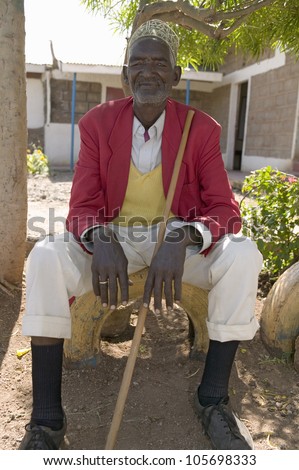 JANUARY 2007 - A Kenyan man sits with red jacket on at the Pepo La Tumaini Jangwani, HIV/AIDS Community Rehabilitation Program, Orphanage & Clinic. Nairobi, Kenya, Africa