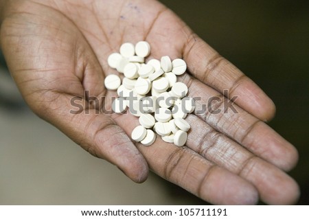 JANUARY 2007 - A closeup of a hand holds AIDS pills at the Pepo La Tumaini Jangwani, HIV/AIDS Community Rehabilitation Program, Orphanage & Clinic. Nairobi, Kenya, Africa