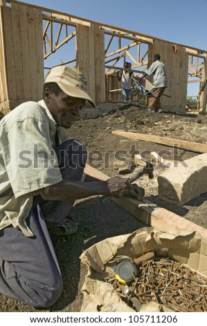 JANUARY 2007 - Man helps construct new houses for Pepo La Tumaini Jangwani, HIV/AIDS Community Rehabilitation Program, Orphanage & Clinic. Nairobi, Kenya, Africa