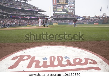 A closeup of Philadelphia Phillies baseball logo on field and displaying a man on the big video screen, from Citizens Bank Park on opening day of baseball, March 31, 2008, Philadelphia, Pennsylvania