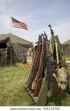 48 star American flag flying over army tent with rifles in foreground, at reenactment of World War II at Mid-Atlantic Air Museum World War II Weekend and Reenactment in Reading, PA held June 18, 2008