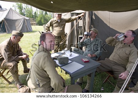 Soldiers relax in front of tent, at Mid-Atlantic Air Museum World War II Weekend and Reenactment in Reading, PA held June 18, 2008