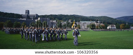 CIRCA 1992 - This is the exterior of the West Point Military Academy. Marching are the Homecoming Parade of Cadets in grey uniforms and tall hats, holding long guns.