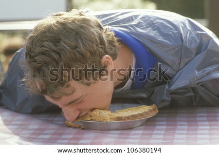CIRCA 2002 - Teenage boy in a pie-eating contest, Knott's Berry Farm, CA
