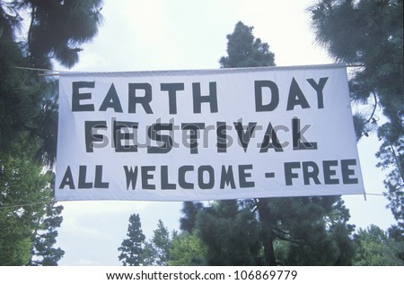 A hanging sign welcoming people to the Earth Day Festival