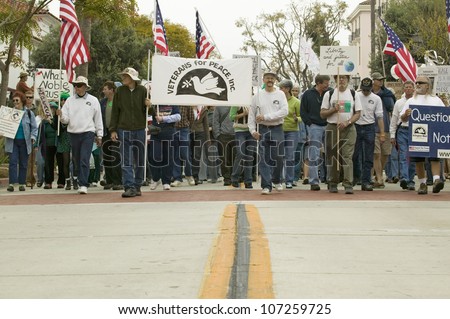 A large crowd of protesters are led by Veterans Against the Iraq War on State Street at an anti-Iraq War protest march in Santa Barbara, California on March 17, 2007