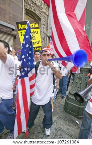 Man blows horn with hundreds of thousands of immigrants participating in march for Immigrants and Mexicans protesting against Illegal Immigration reform by U.S. Congress, Los Angeles, CA, May 1, 2006