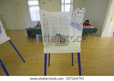 NOVEMBER 2004 - Election volunteers and voting booths in a polling place, CA