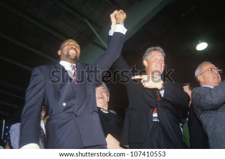 Governor Bill Clinton joins hands with Boxer Tommy Heams during a Detroit campaign rally in 1992 on his final day of campaigning in Detroit, Michigan