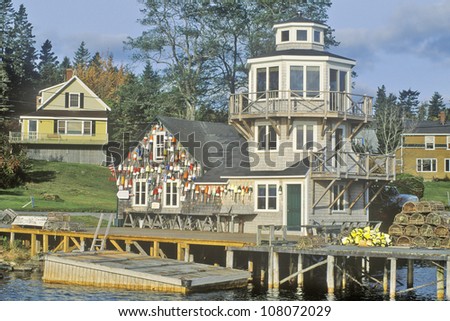Floats from fishing nets hang on the side of a lighthouse in Stonington, Mount Desert Island, Maine