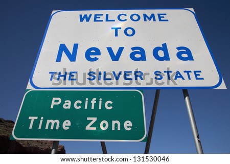 Welcome to Nevada sign with Pacific Time Zone sign