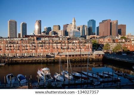 BOSTON - JUNE 14: Boats at Lewis Wharf with Boston Skyline and Custom House Tower in the background on June 14, 2012 in Boston, MA