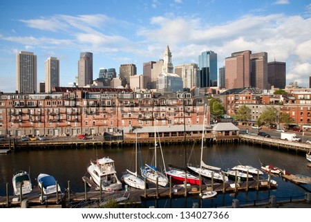 BOSTON - JUNE 14: Boats at Lewis Wharf with Boston Skyline and Custom House Tower in the background on June 14, 2012 in Boston, MA