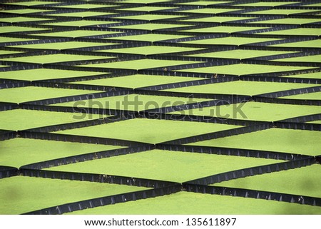 Green diamond pattern like shapes at a water treatment plant