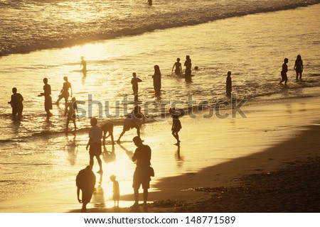 SANTA MONICA, LOS ANGELES, CA  - CIRCA 1980\'s: People on beach at sunset in Santa Monica, CA