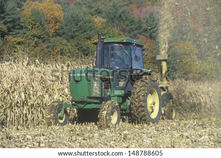 NEW ENGLAND - CIRCA 1990\'s: Farmer cutting corn with tractor in New England