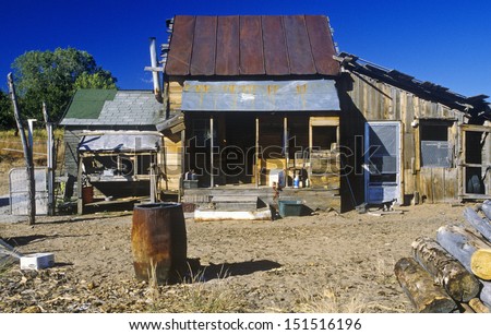 NEVADA - CIRCA 1980\'s: Old ramshackle dwelling with oil drum in dirt yard