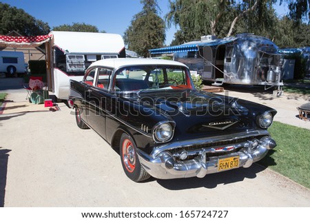 Exterior view of a vintage trailer and 1957 Chevrolet car, at the 4th Annual Vintage Trailer Bash, Flying Flag RV Resort, Buellton, California September 2013