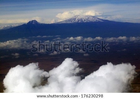 Aerial image of Mount Kilimanjaro, Africa\'s highest mountain, with snow and white puffy clouds from Kenya