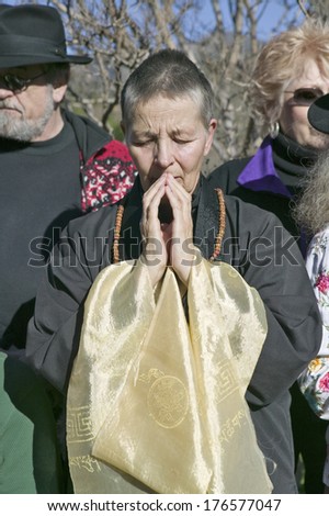 Devotee stands in prayerful meditation at Amitabha Empowerment Buddhist Ceremony, Meditation Mount in Ojai, CA