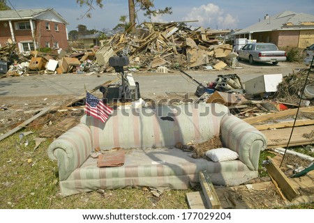 American Flag on couch and debris in front of house heavily hit by Hurricane Ivan in Pensacola Florida