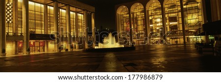 This is Lincoln Center at night. It is the home of the New York City Ballet and other cultural institutions. The fountain is running and lighted.