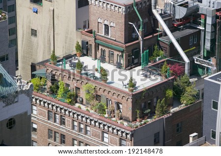 Trees and plants grow on outdoor deck of New York City apartment building in Manhattan, New York