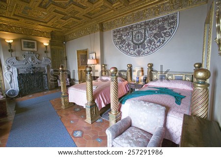 Interior of guest bedroom with displayed antique clothing of the day at Hearst Castle, \