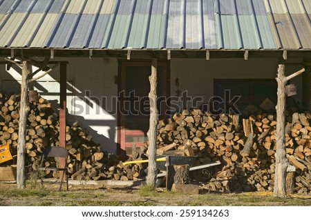 Stack of logs in front of cabin in Mescalero Apache Indian Reservation near Ruidoso and Alto, New Mexico