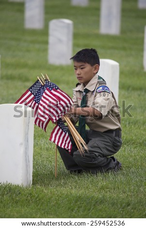 Boyscout places one of 85, 000 US Flags at 2014 Memorial Day Event, Los Angeles National Cemetery, California, USA, 05.24.2014