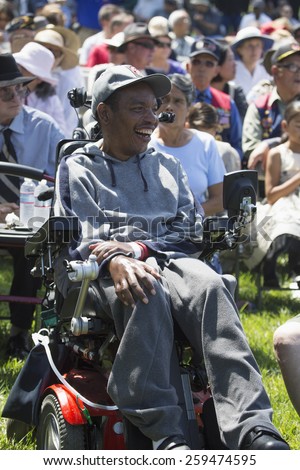 Smiling disabled veteran in wheel chair at Los Angeles National Cemetery Annual Memorial Event, May 26, 2014, California, USA, 05.26.2014