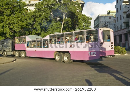 Pink and purple camel bus driving through streets of Old Havana, Cuba