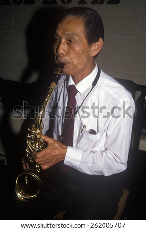 Musician with brass wind instrument in Old Jazz Band at Peace Hotel, Shanghai, People's Republic of China