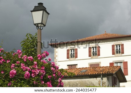 Summer flowers, lamp post and home in Sare, France in Basque Country on Spanish-French border, a hilltop 17th century village in the Labourd province.