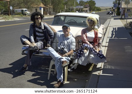 Photographer Joe Sohm posing with dummies on back bumper of antique car in Seligman, Arizona, old Route 66