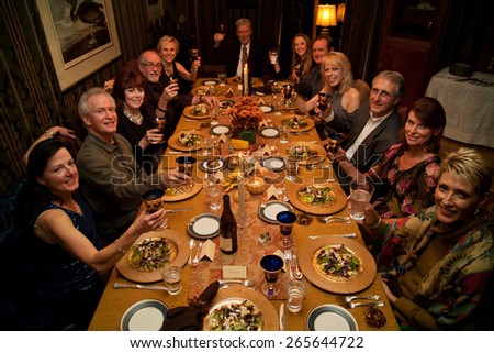 Thanksgiving toast at long dinner table before Thanksgiving dinner, 2011, Ojai, CA