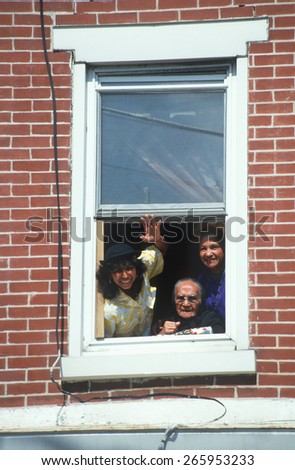 A Puerto Rican family waving from their apartment window, Wilmington, DE