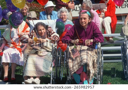 A group of elderly women in wheelchairs watching a parade, Northern CA
