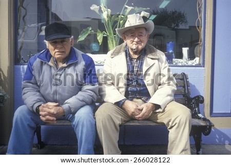 Two older men sitting on a bench, Half Moon Bay, CA