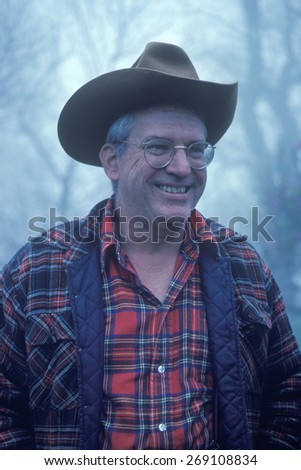 A man in a cowboy hat and flannel shirt smiling, Monticello, VA
