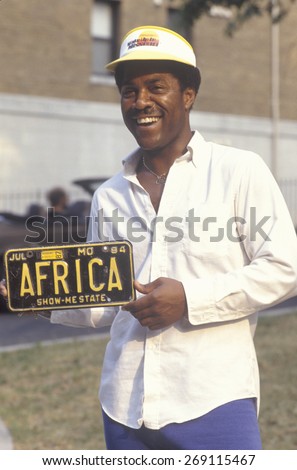 An African-American man holding a personalized license plate, Washington, D.C.