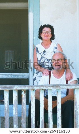 An happy older couple on their porch in NM